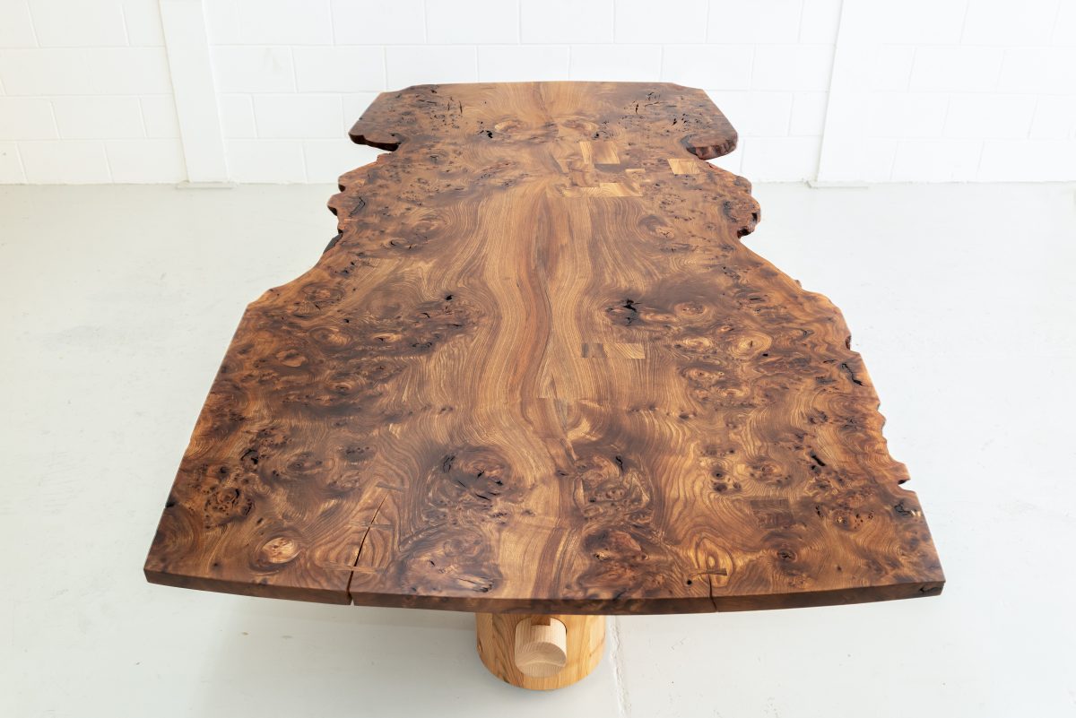 Nakashima-inspired, 12 seater table, made from highly figured Scottish Elm. Inlaid geometric pieces are used to replace surface defects. Hand carved pin-striping and profiling