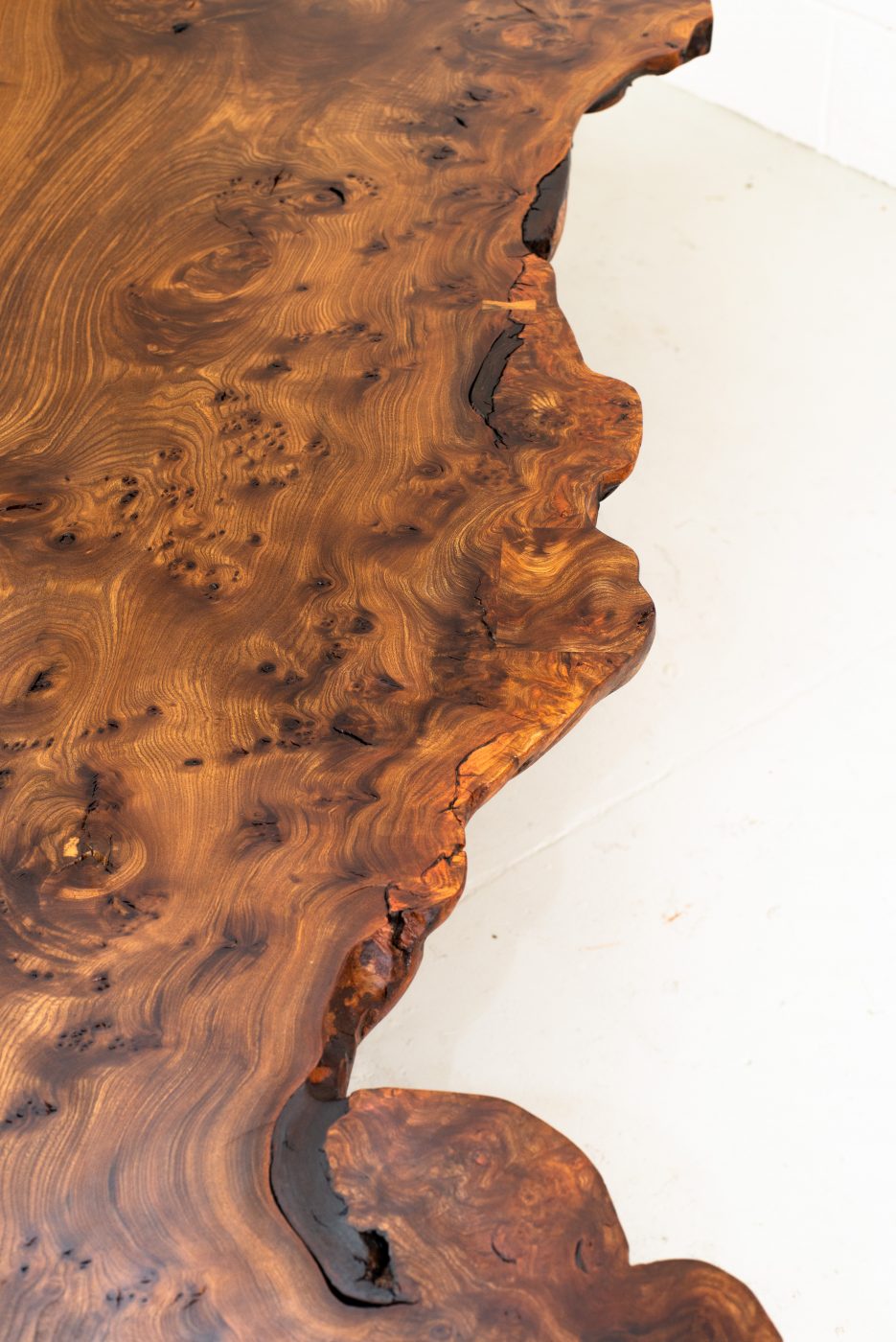 Nakashima-inspired, 12 seater table, made from highly figured Scottish Elm. Inlaid geometric pieces are used to replace surface defects. Hand carved pin-striping and profiling
