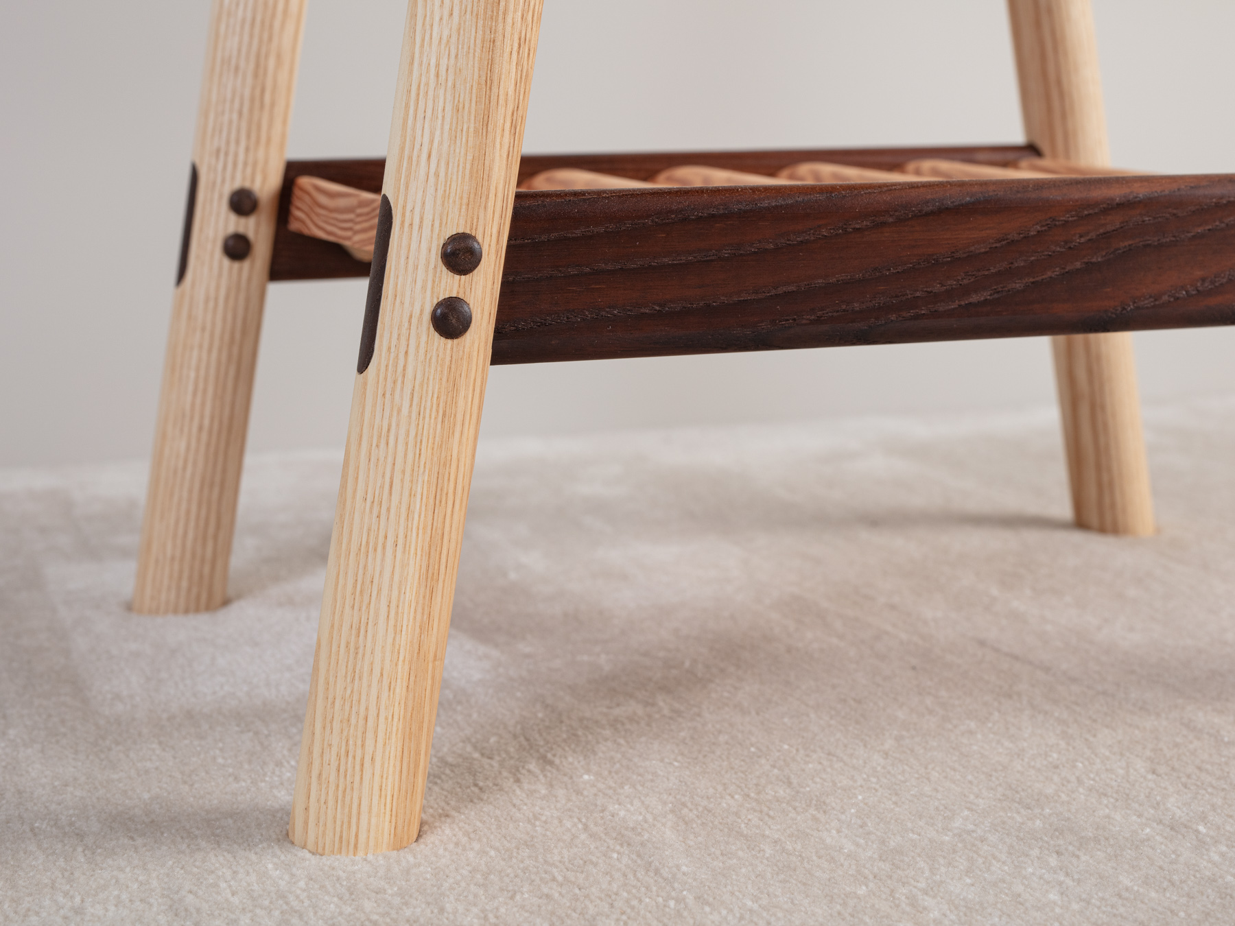 A four-legged table with hand turned dowel sections. Mortice and tenon rails, with accentuated dowel button detailing. A tippled Douglas fir shelf below accentuates the timber's stunning natural grain detail.