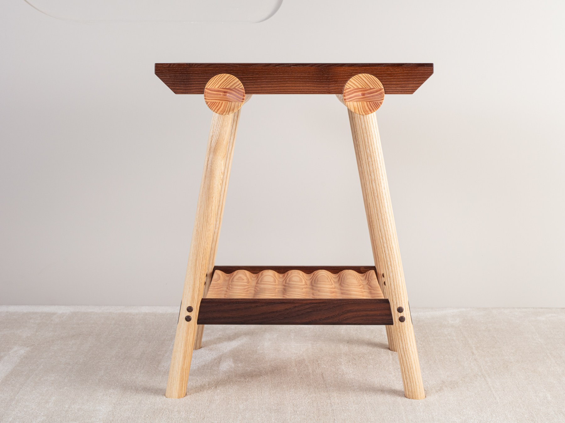 A four-legged table with hand turned dowel sections. Mortice and tenon rails, with accentuated dowel button detailing. A tippled Douglas fir shelf below accentuates the timber's stunning natural grain detail.