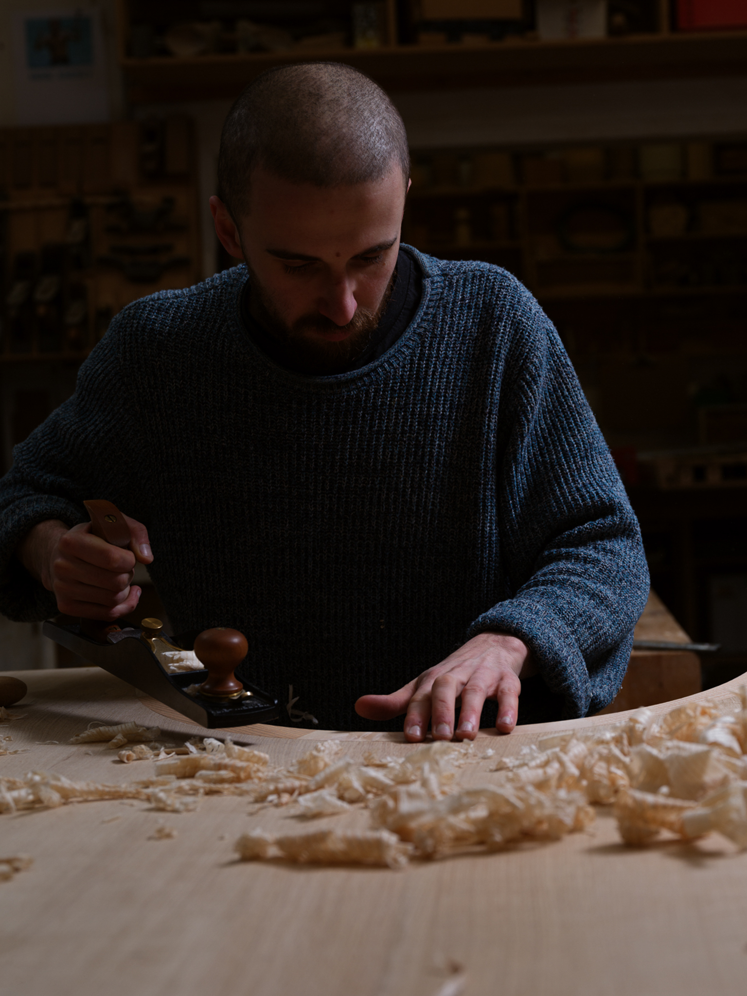 jan hendzel studio's wooden sculpture for park avenue hotel in new york view of man planing wood