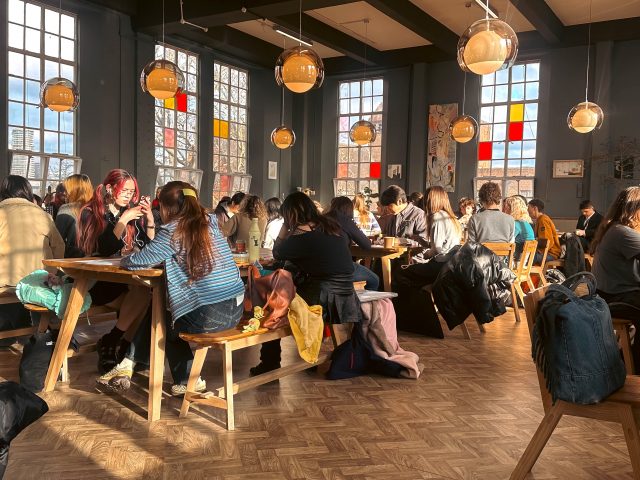 Students using the Camberwell Canteen Collection furniture by Jan Hendzel Studio in the busy UAL Lime Grove café